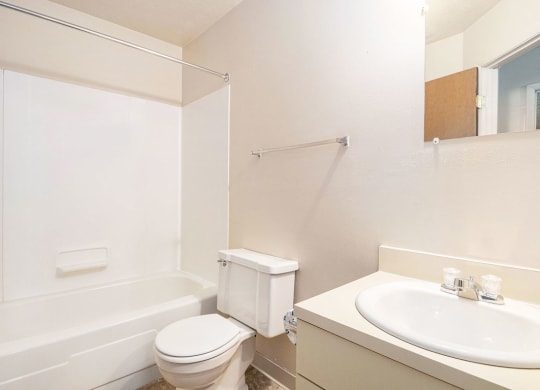 a bathroom with a sink toilet and bathtub at Hickory Village Apartments, Mishawaka, Indiana
