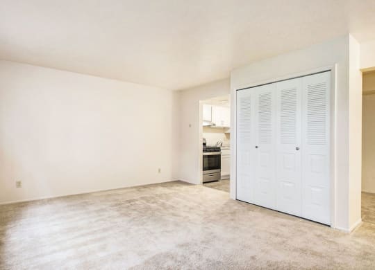 an empty living room with a kitchen in the background at Hickory Village Apartments, Mishawaka, IN, 46545