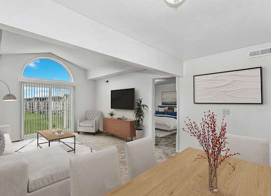 A living room with a couch and a wooden table at The Highlands Apartments, Elkhart, Indiana