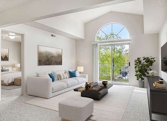 A living room with a cathedral ceiling at The Highlands Apartments in Elkhart, IN