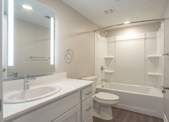 New Bathroom Upgrade with new countertops and mirror at Hillside Apartments, Wixom, MI