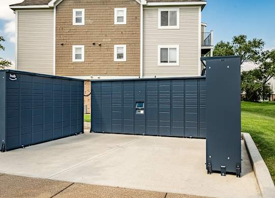 A large blue garage door in front of a two-story apartment building