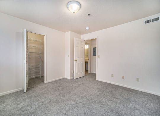 an empty bedroom with a walk-in closet