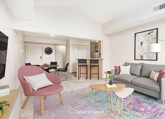 A living and dining room with a grey couch and a high ceiling at Hurwich Farms Apartments, Indiana