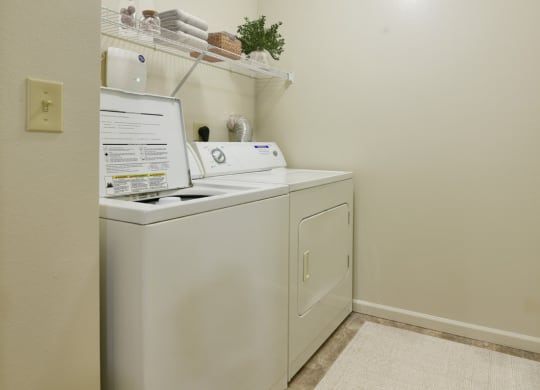 a washer and dryer in our resident laundry room at Heatherwood Apartments, Grand Blanc