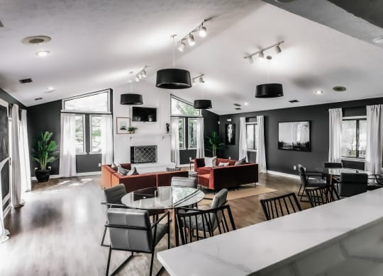 a living room with black walls and a white table and chairs Indy