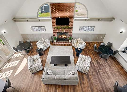 A community room with a fireplace and a couch at Indian Lakes Apartments, Mishawaka, Indiana