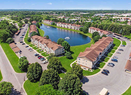 A large pond is surrounded by apartment buildings at Indian Lakes Apartments, Mishawaka, Indiana