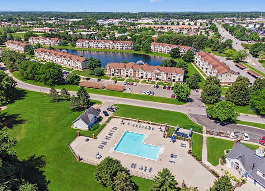 A large apartment complex with a swimming pool in the foreground at Indian Lakes Apartments, Mishawaka, Indiana