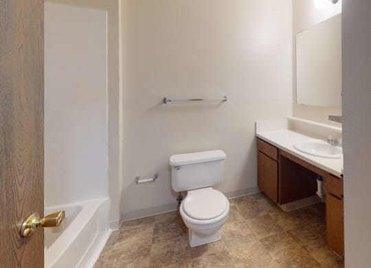 a bathroom with a toilet and a sink at Indian Lakes Apartments, Mishawaka, Indiana