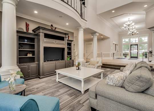 A living room with a blue couch and a white coffee table at Westlake Apartments, Michigan