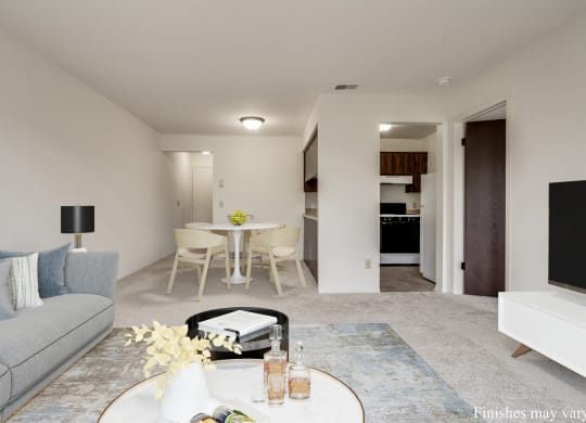 a living room with a couch and a table in front of a tv at The Landings Apartments, Westland at The Landings Apartments, Michigan