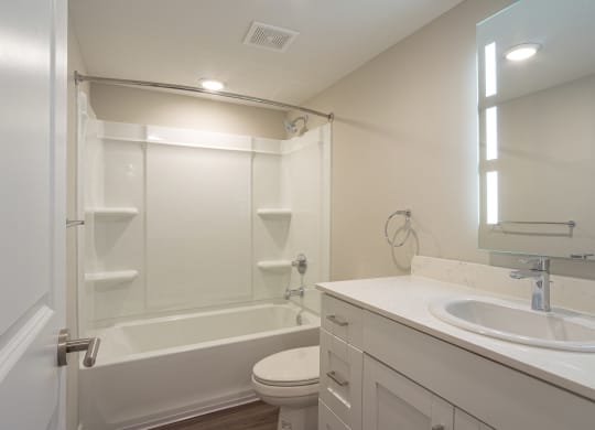a bathroom with a sink toilet and bathtub at Hillside Apartments, Michigan