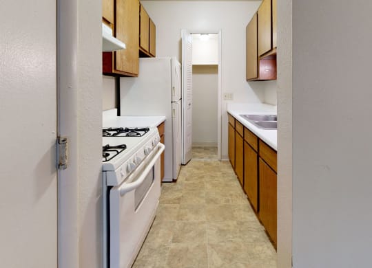 a kitchen with a gas stove and a pantry at Irish Hills Apartments, South Bend, IN