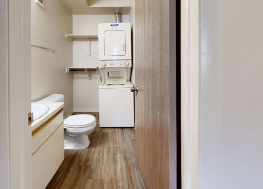 a second bathroom with a stackable washer/dryer
