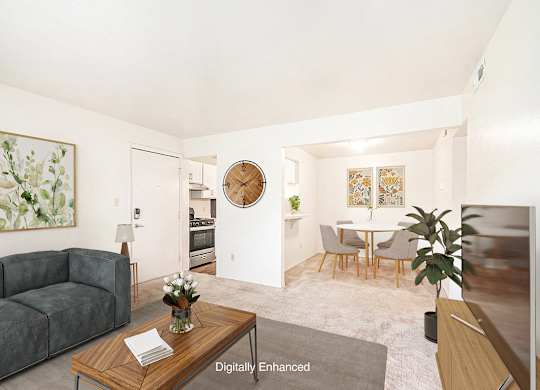 A living room with a couch and a dining room with a breakfast bar  and table with chairs at Irish Hills Apartments, South Bend, Indiana