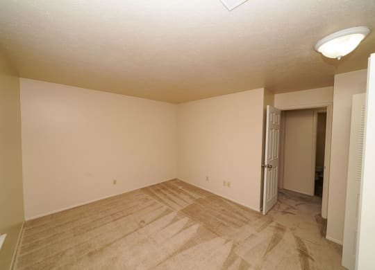 A large bedroom with plush carpeting at Irish Hills Apartments, Indiana