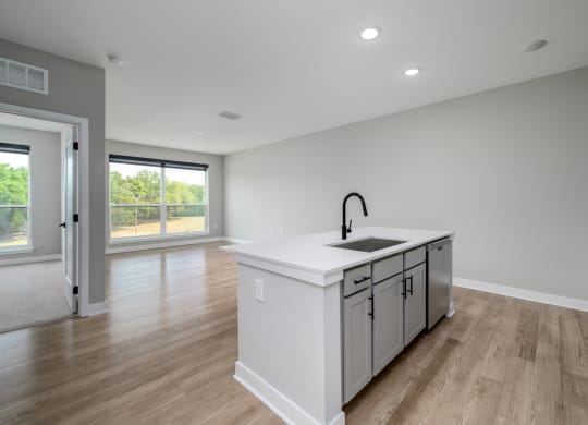 a large white kitchen with a large island in the middle at Ironwood Flats in Brandon, FL 33511