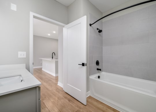 a white bathroom with a tub and a sink at Ironwood Flats in Florida 33511