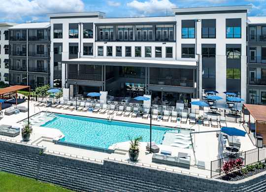 A large building with a pool in front at Ironwood Flats Apartments, Brandon, Florida