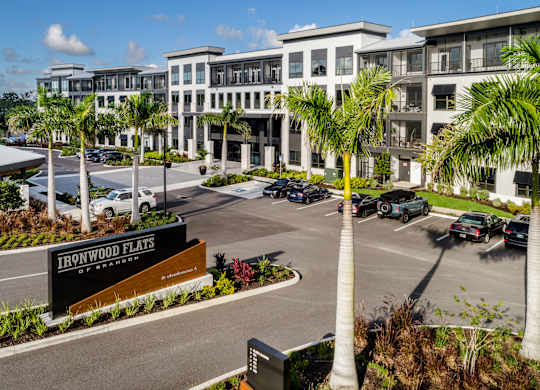 A view of a parking lot in front of a building named Ironwood Flats at Ironwood Flats Apartments, Brandon, 33511