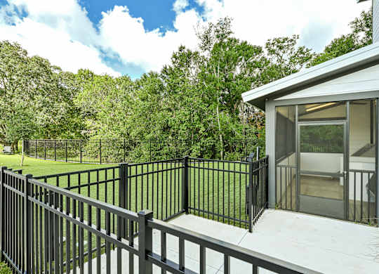 A house with a black fence and a glass door at Ironwood Flats Apartments, Florida, 33511