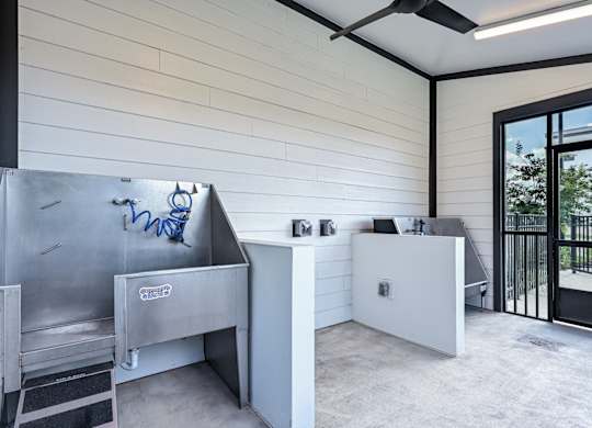 A modern kitchen with a stainless steel sink and a white countertop at Ironwood Flats Apartments, Brandon, Florida