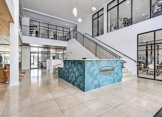 A reception area with a blue counter and a staircase at Ironwood Flats Apartments, Brandon