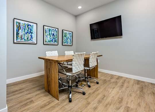 A conference room with a wooden table and chairs at Ironwood Flats Apartments, Florida