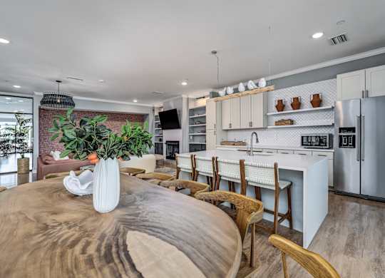 A modern kitchen with a wooden table and chairs at Ironwood Flats Apartments, Brandon