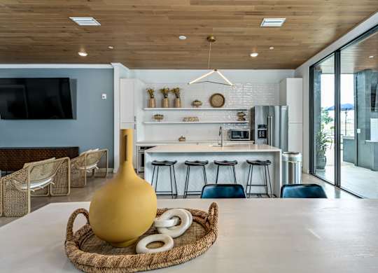 A modern kitchen with a wooden ceiling and a large yellow vase on a woven tray at Ironwood Flats Apartments, Brandon, FL