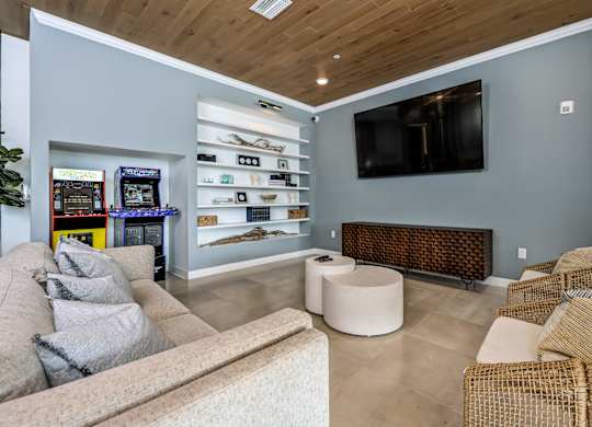 A living room with a couch, a chair, and a television at Ironwood Flats Apartments, Brandon, 33511