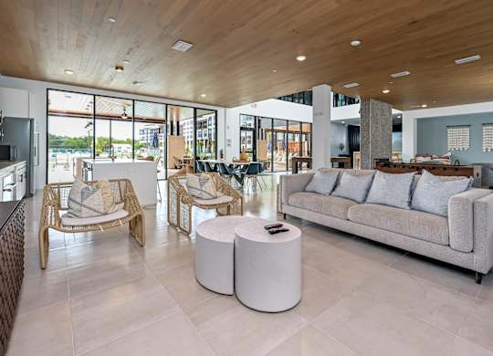 A modern living room with a wooden ceiling and a large window at Ironwood Flats Apartments, Brandon, FL