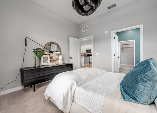 a bedroom with grey walls and a white bed at Ironwood Flats, Brandon, FL