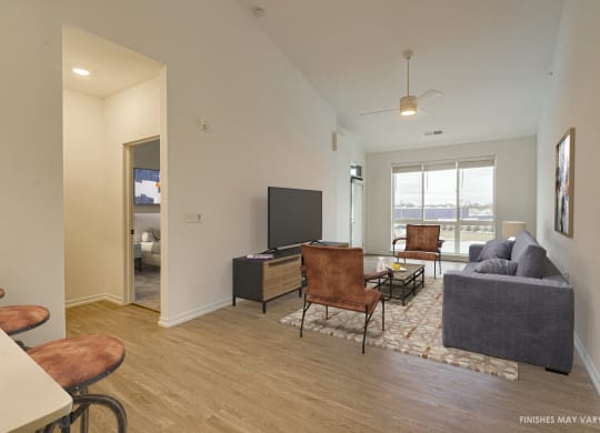 a living room with hardwood flooring and a flat screen tv  at Uptown Square Apartments, Michigan