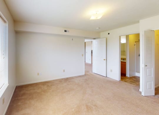 Large master bedroom with a walk-in closet and attached bathroom at Limestone Creek Apartment Homes, Alabama