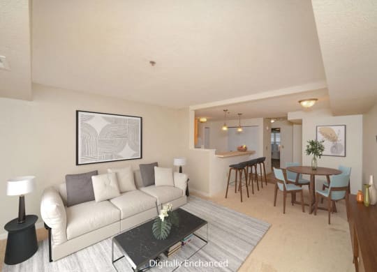 a living room and dining room with a couch and a table at Limestone Creek Apartment Homes, Madison, AL
