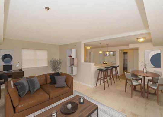 an end style living room and dining room with a couch and a table at Limestone Creek Apartment Homes, Madison, AL