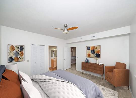 bedroom with a bed and a ceiling fan with attached bathroom at Limestone Creek Apartment Homes, Madison, AL