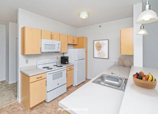a two bedroom kitchen with white appliances and wooden cabinets at Limestone Creek Apartment Homes, Madison, AL