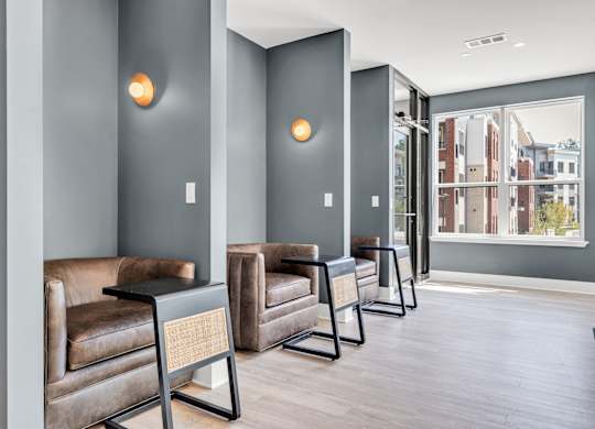 A row of brown leather chairs are lined up in a hallway at Luxe 360 on Centerpointe Apartments, Virginia, 23114