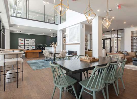 A modern dining room with a black table and green chairs at Luxe 360 on Centerpointe Apartments, Midlothian, VA, 23114