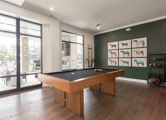 A pool table in a room with a green wall and pictures of animals at Luxe 360 on Centerpointe Apartments, Midlothian, 23114