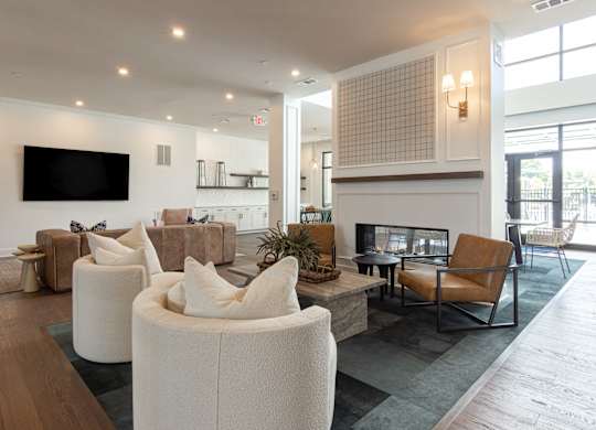A modern living room with a flat screen TV mounted on the wall at Luxe 360 on Centerpointe Apartments, Virginia, 23114