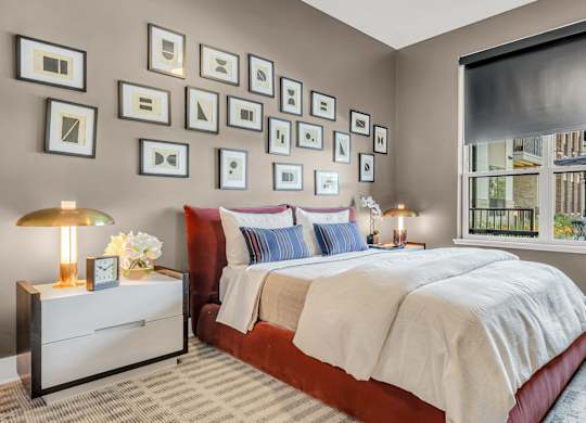 A bedroom with a large bed and a nightstand with a lamp at Luxe 360 on Centerpointe Apartments, Midlothian