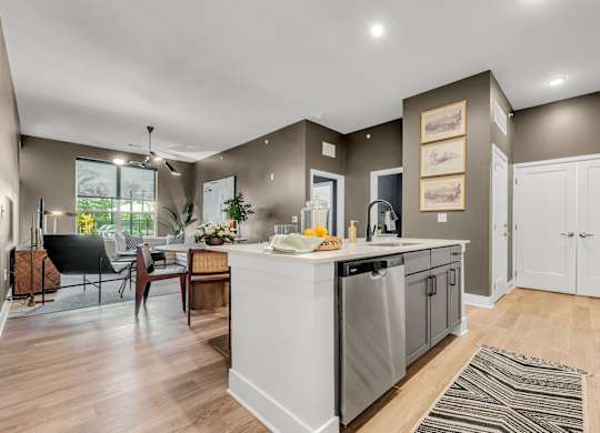 A modern kitchen with a dining table and chairs at Luxe 360 on Centerpointe Apartments, Midlothian