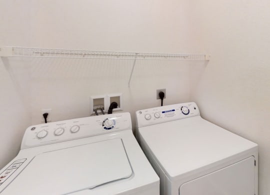 A washer and dryer in a laundry room at Lynbrook Apartment Homes and Townhomes, Elkhorn