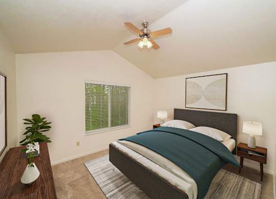 A master bedroom with a cathedral ceiling and ceiling fan at Lynbrook Apartments and Townhomes, Nebraska
