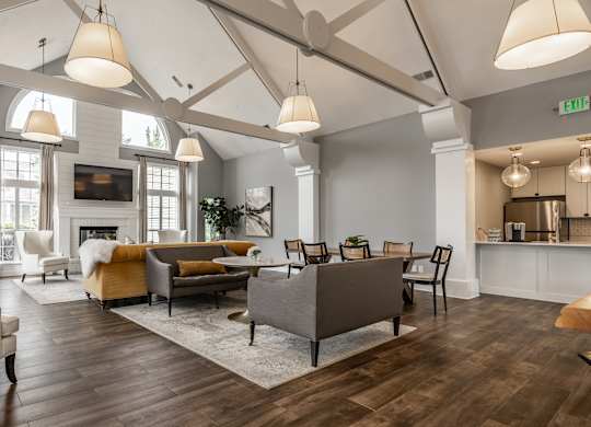 A living room with a white chair and a grey sofa at Mallard Bay Apartments, Crown Point, Indiana