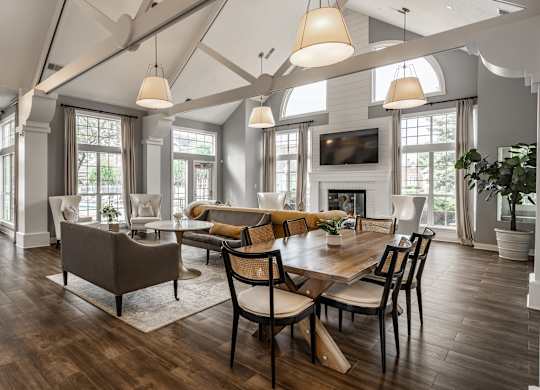 A large, well-lit dining room with a wooden table and chairs at Mallard Bay Apartments, Crown Point, Indiana